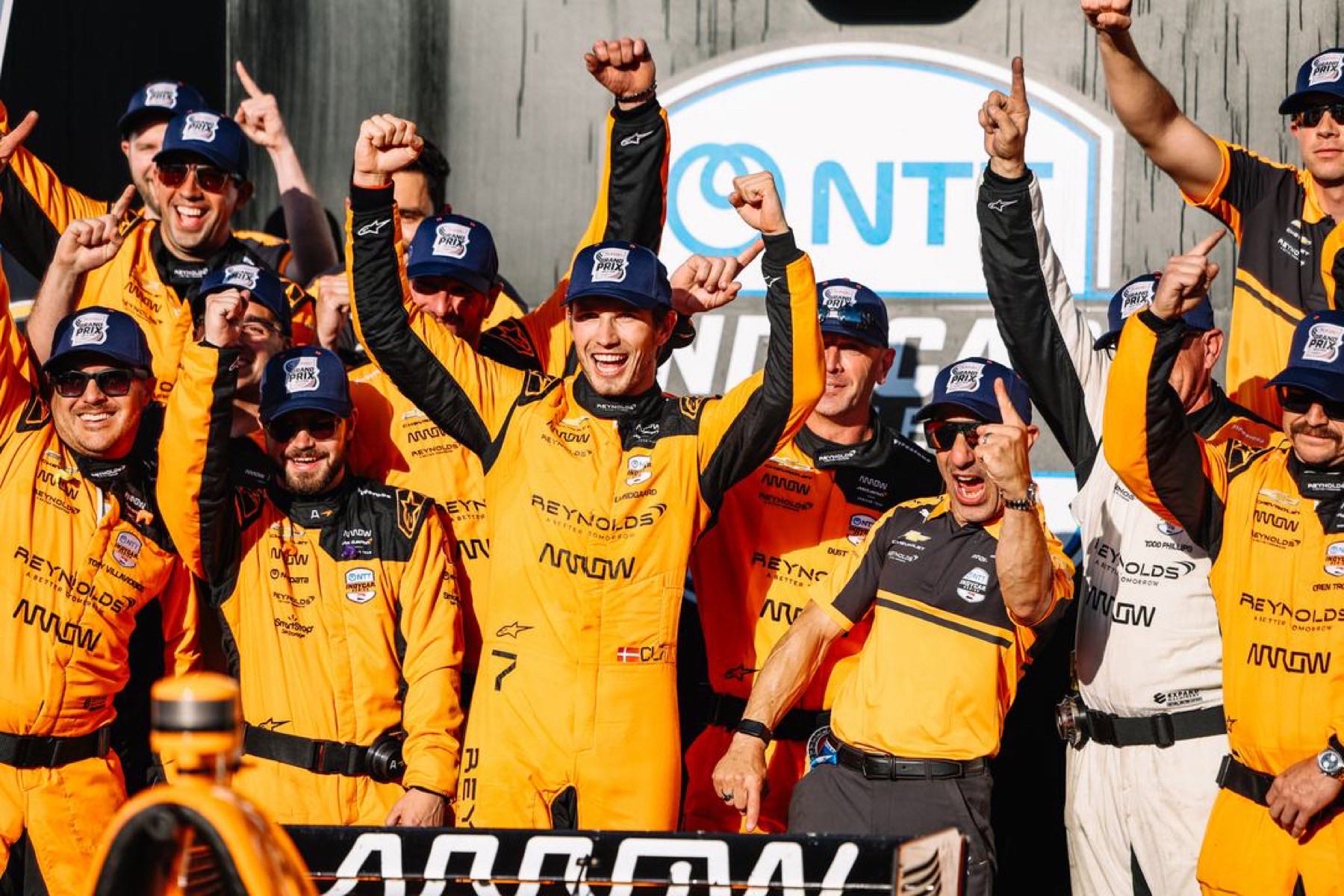 Christian Lundgaard and the Arrow McLaren team celebrate in Victory Lane after winning the Sonsio Grand Prix at the Indianapolis Motor Speedway road course